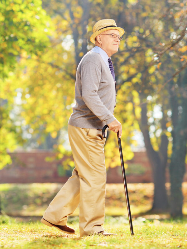 Senior walking with a cane in a park